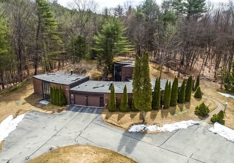 A large house with trees in the background